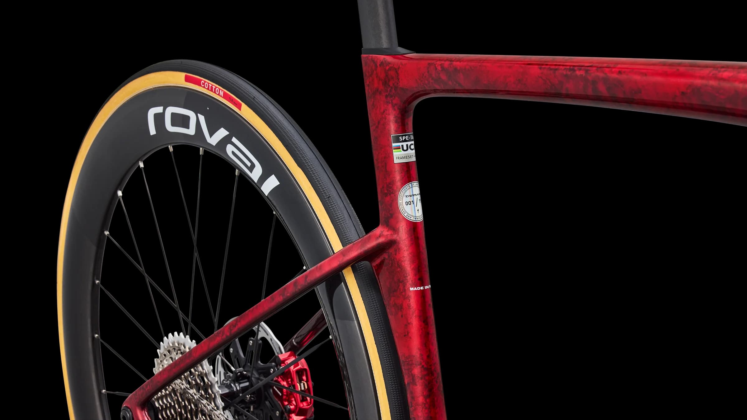 Close-up of the hand-finished Race Red paint and the numbered plaque on the seat tube